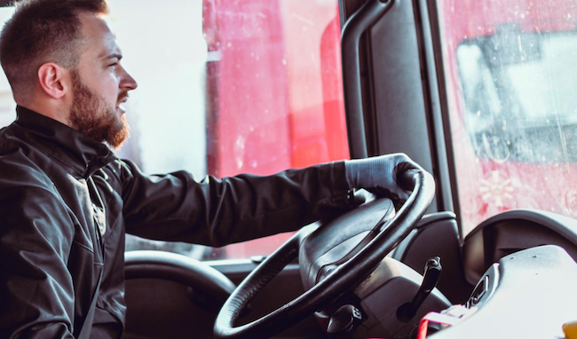interior de la cabina de un camión, con el conductor al volante